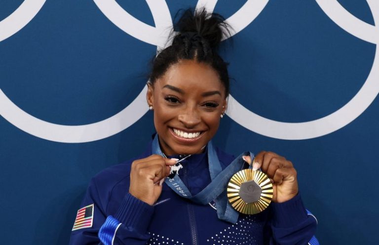 Simone Biles pulls out GOAT necklace with 546 diamonds in it